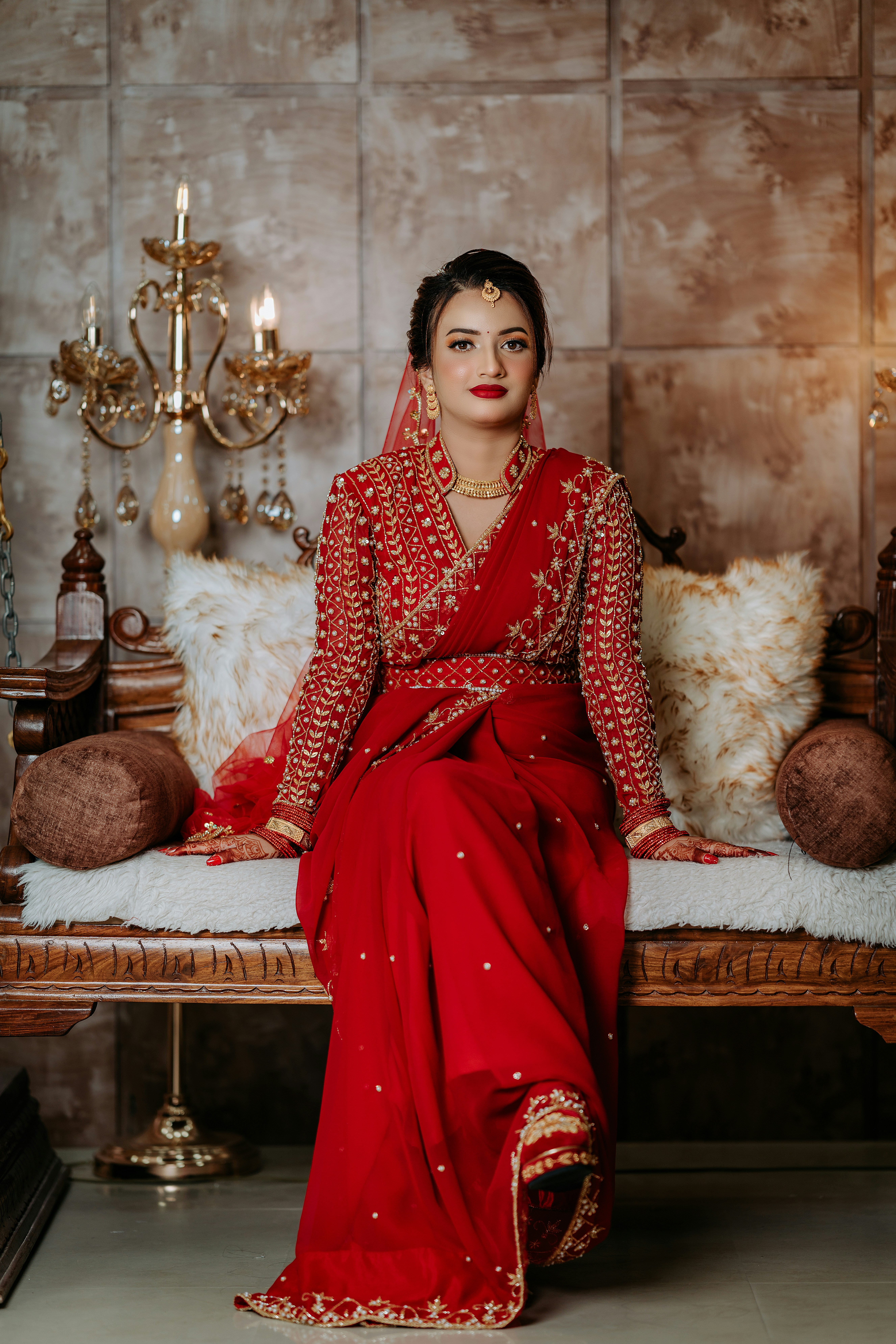 A woman in a red dress sitting on a bench