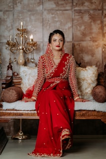 A woman in a red dress sitting on a bench