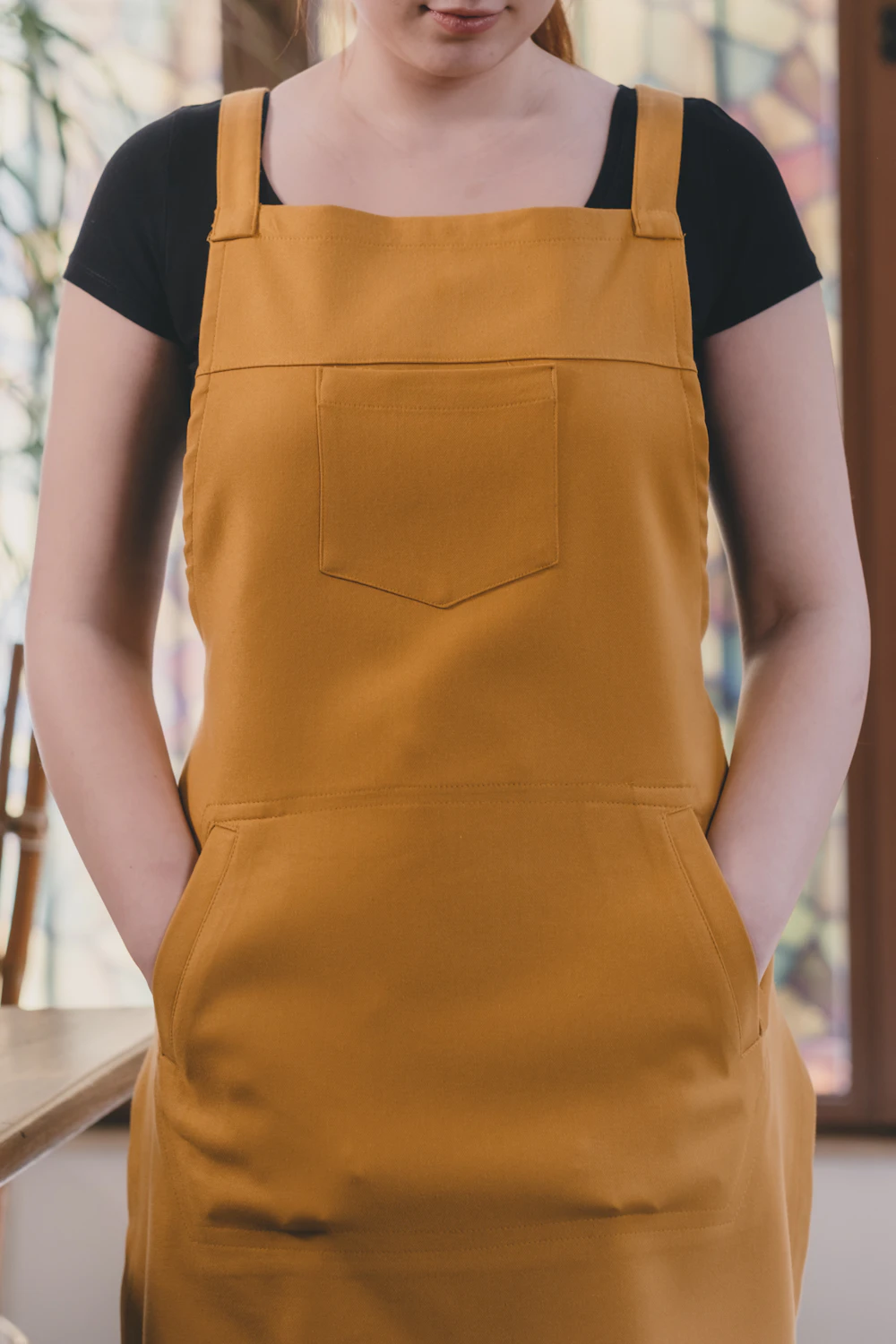 Chef in an apron standing in a home kitchen
