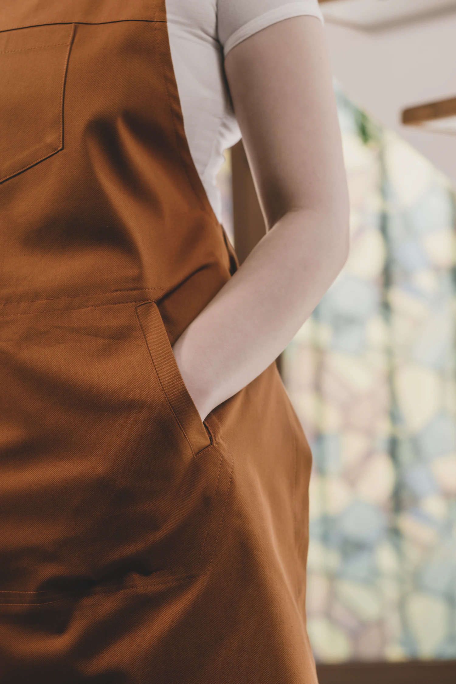 A close crop of an ochre apron pocket