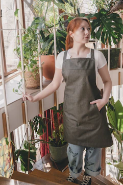 A woman in an apron standing on a stair case