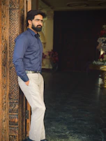 A man standing in a doorway with his hands in his pockets