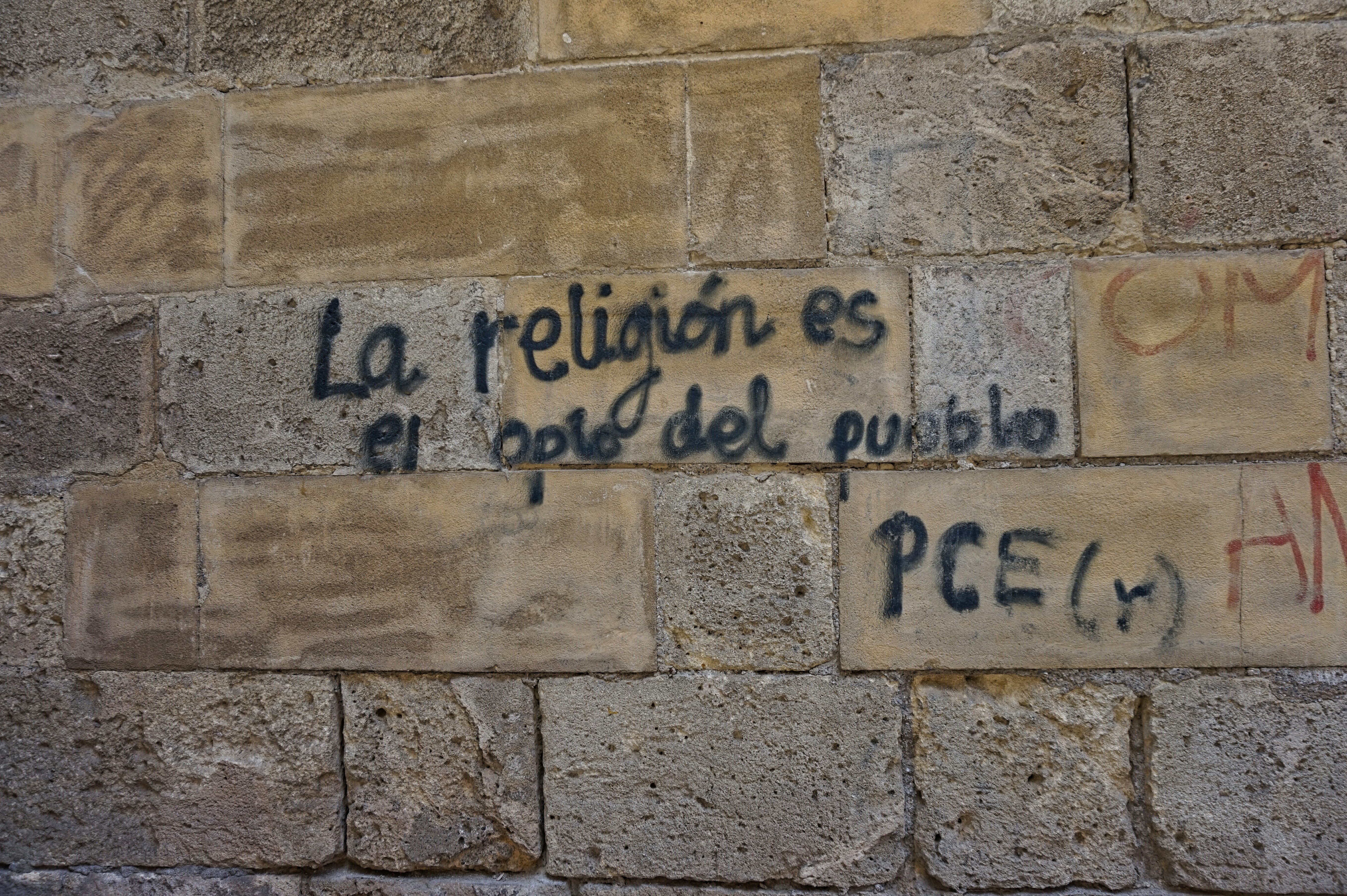 A brick wall with graffiti written on it