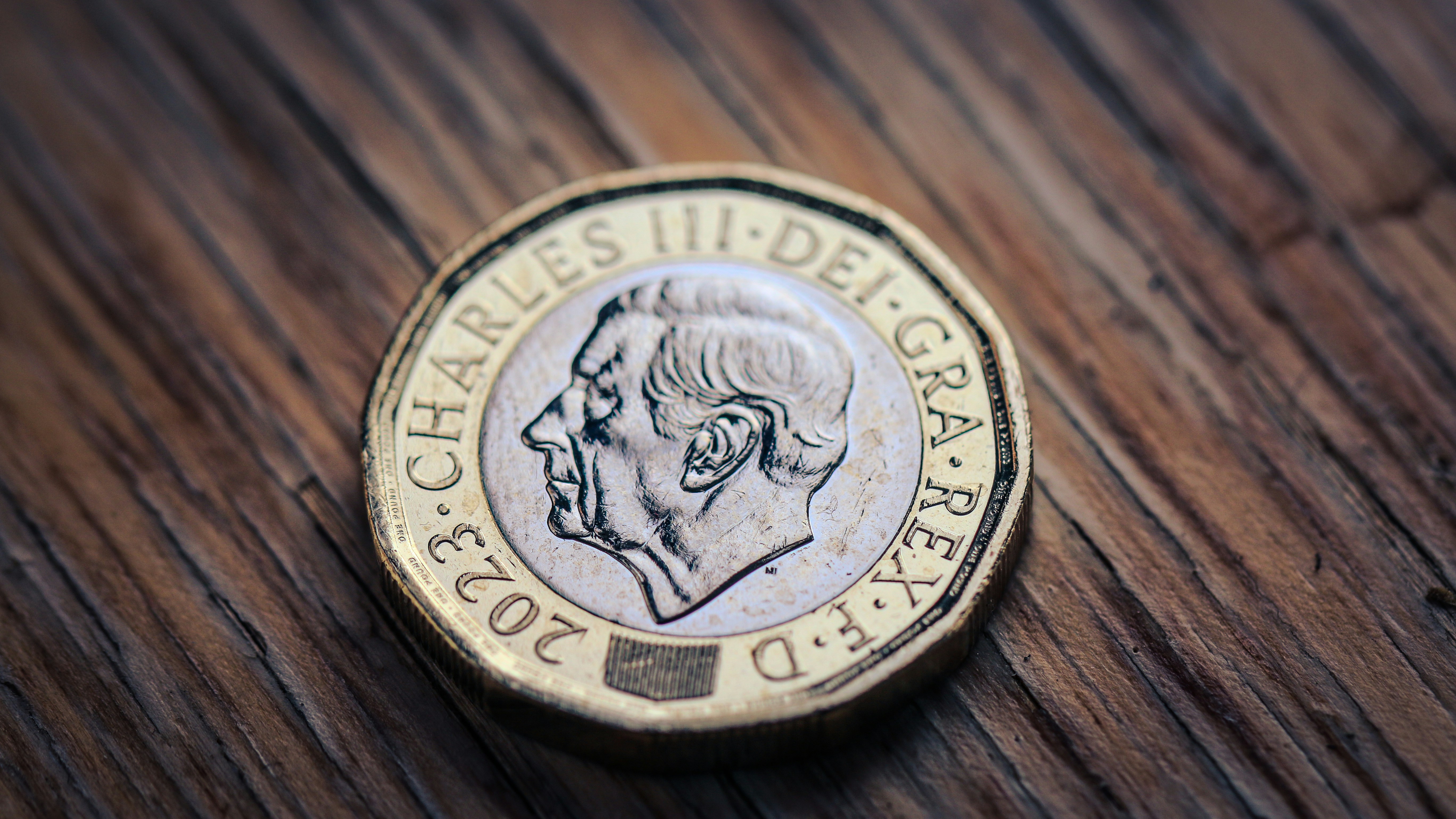 A coin sitting on top of a wooden table