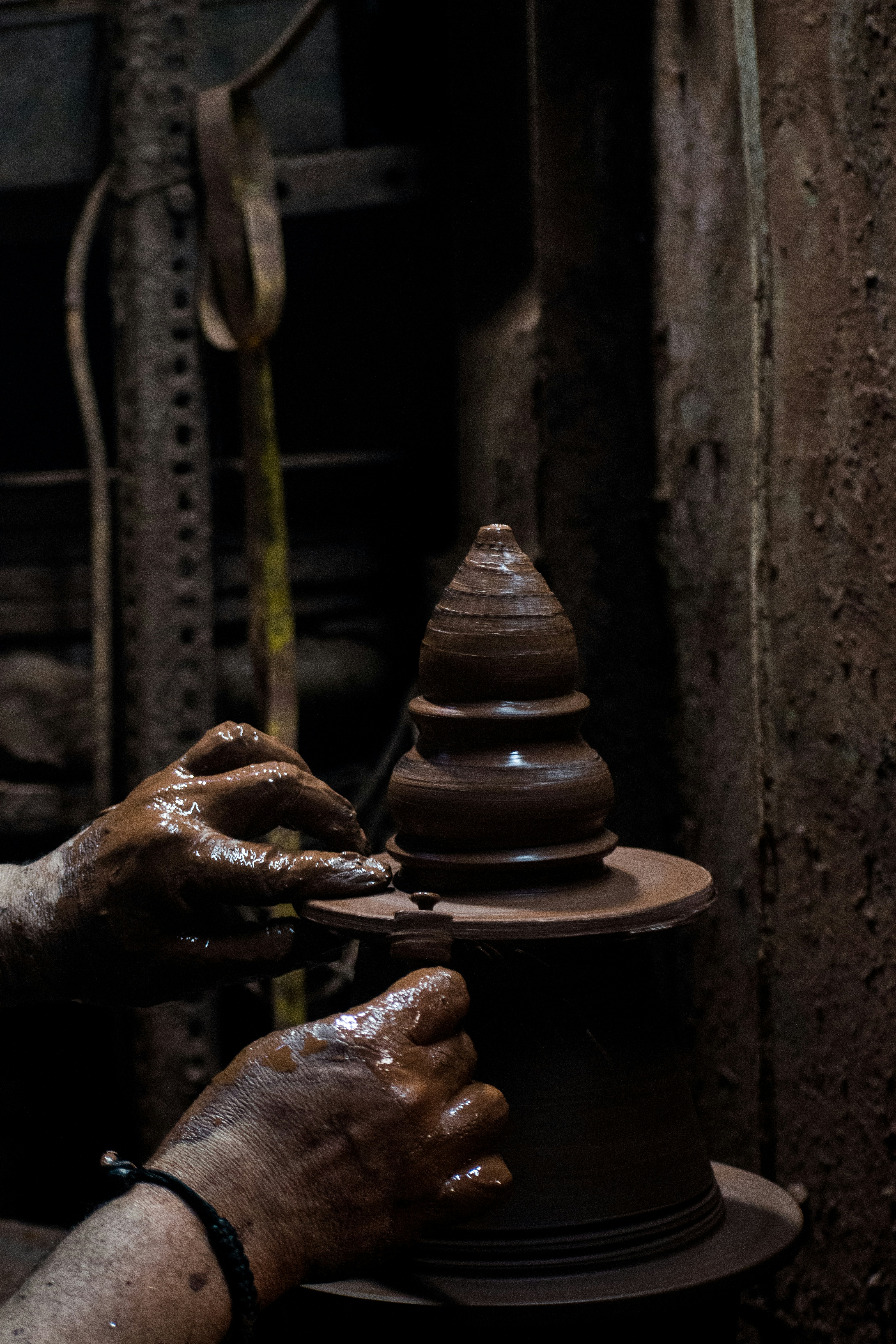 A person making a vase out of clay