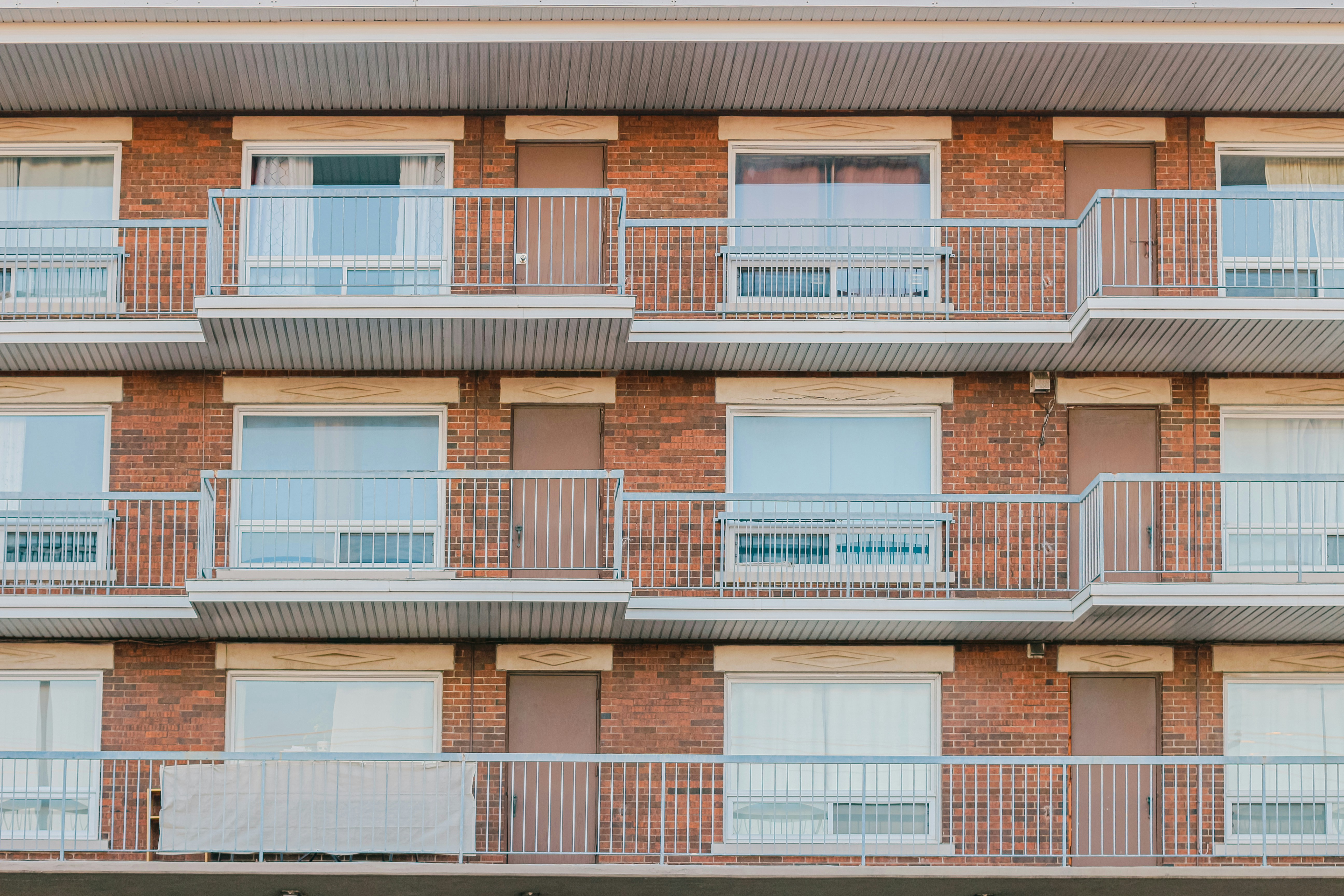 A tall brick building with balconies and balconies