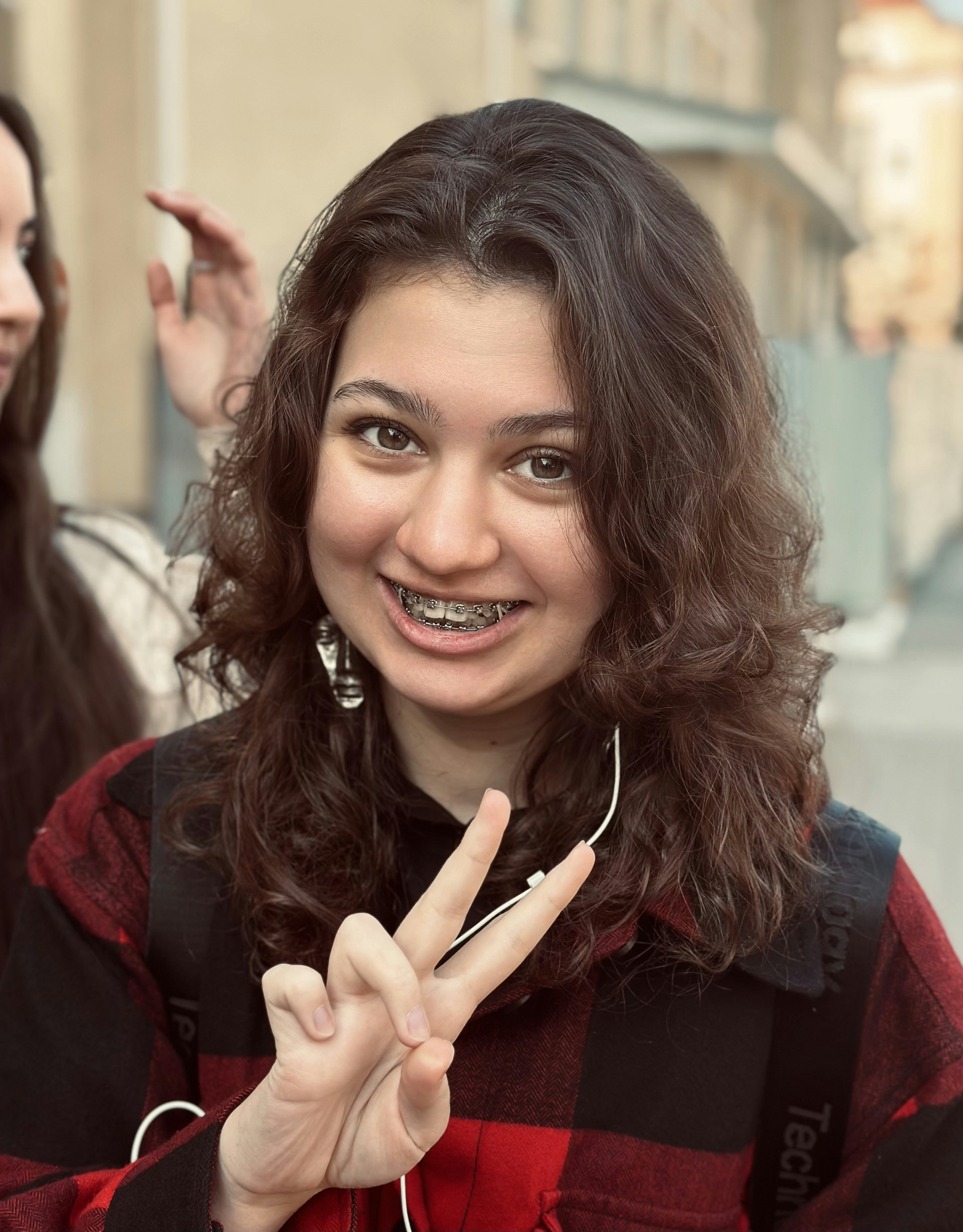 A woman making a peace sign with her fingers