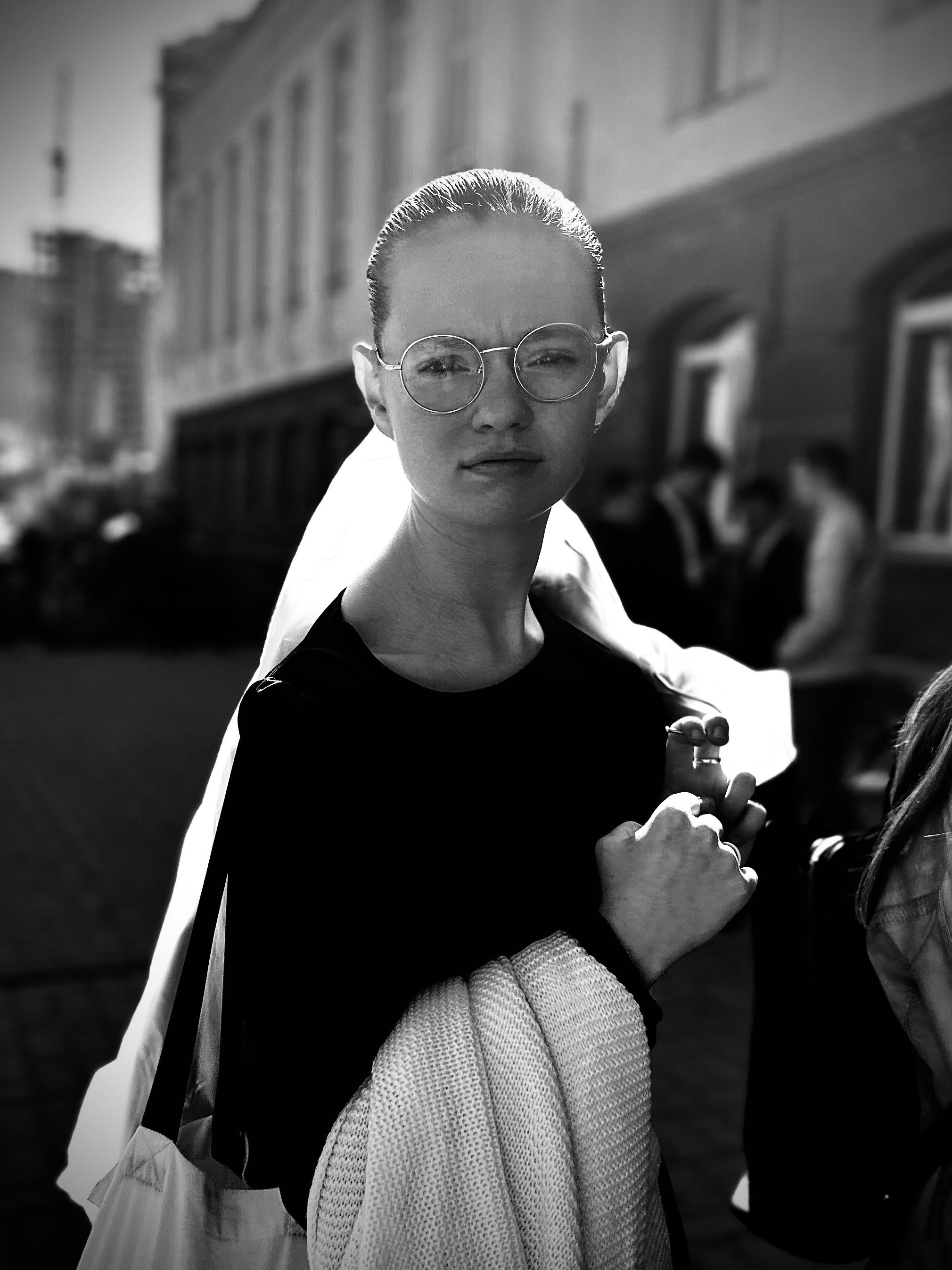 A black and white photo of a woman wearing glasses