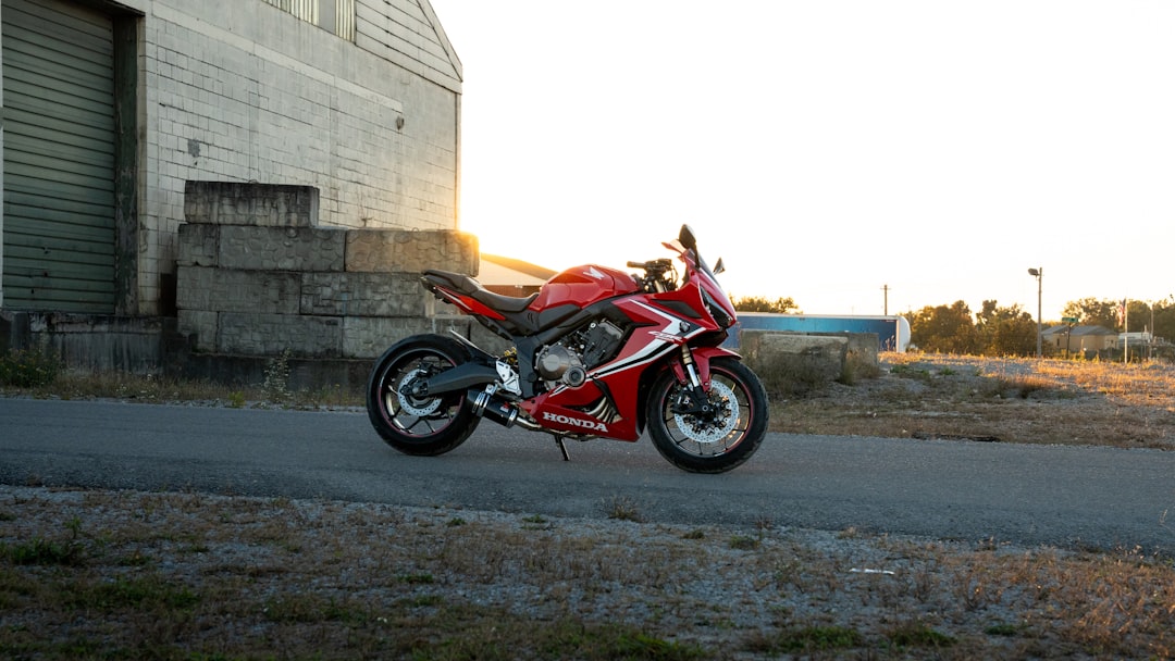 A red motorcycle parked on the side of a road
