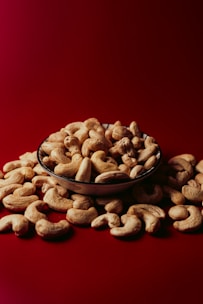 A bowl of nuts on a red background