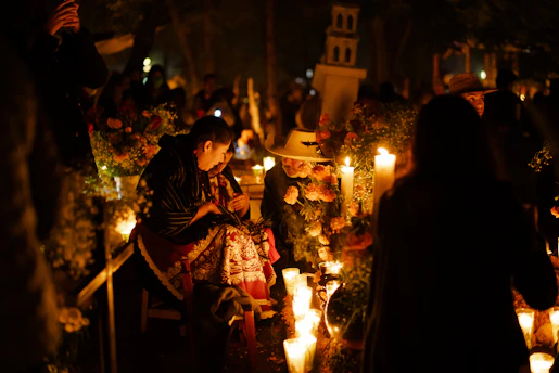 A group of people standing around a bunch of candles