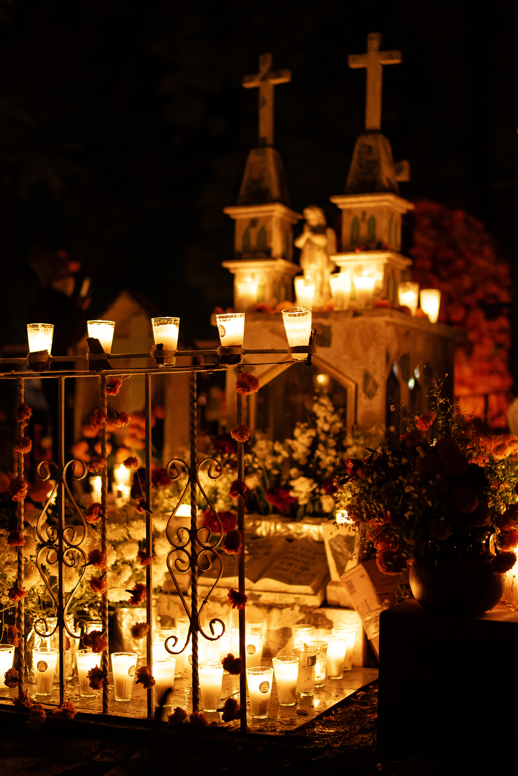 Velas encendidas frente a una iglesia en Día de Muertos
