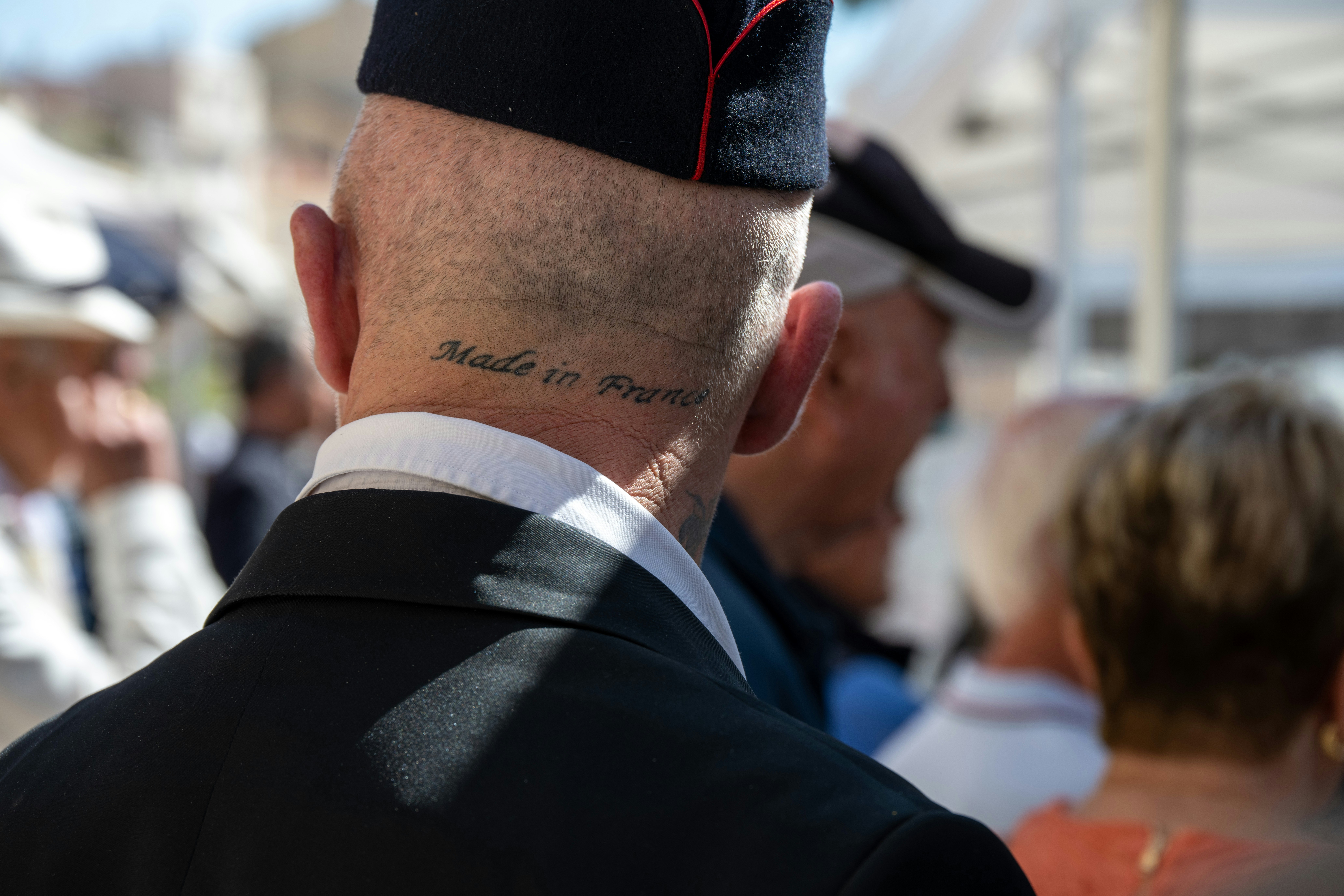 A man in a military uniform standing in a crowd