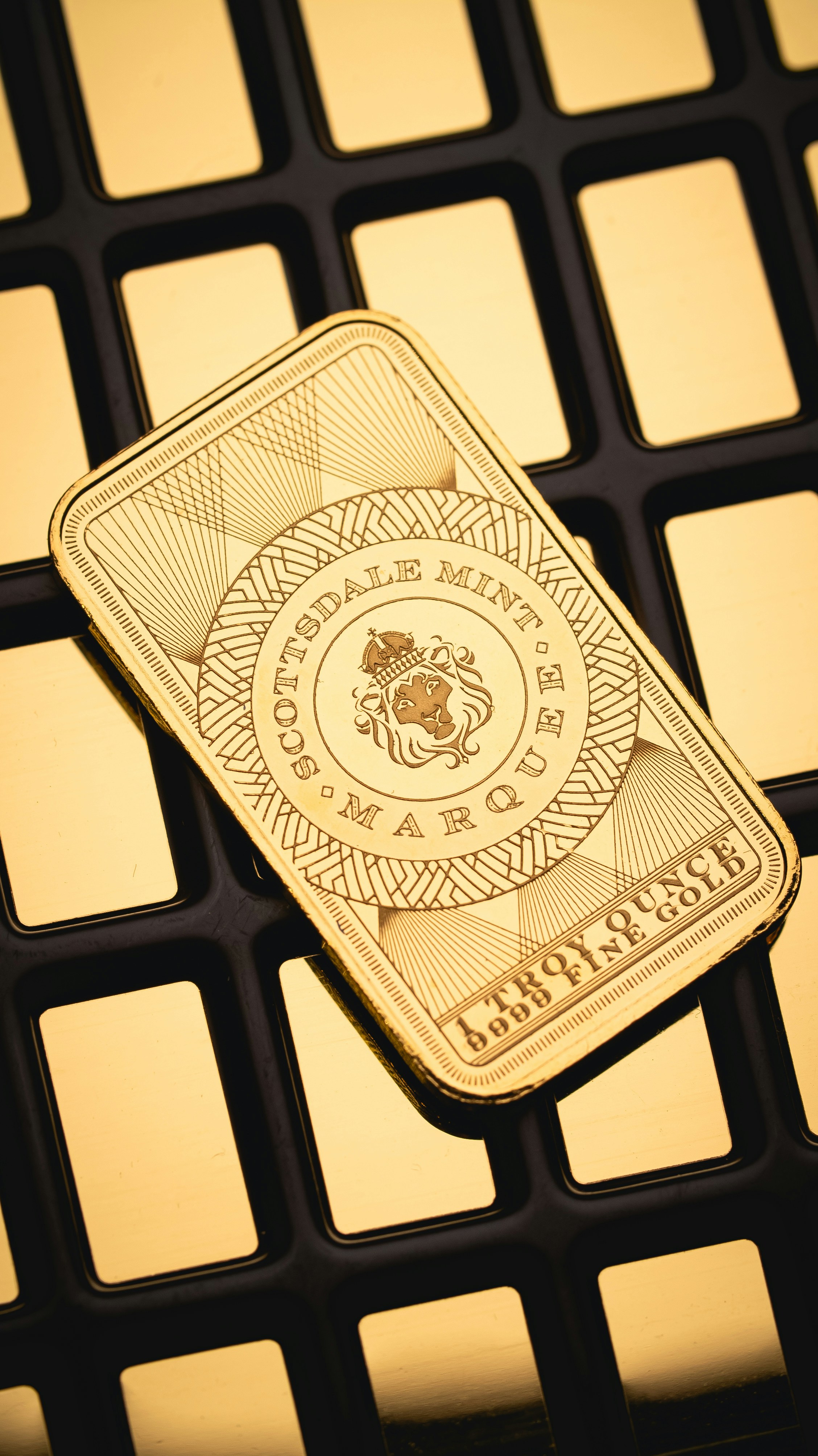 A gold bar sitting on top of a computer keyboard