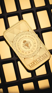 A gold bar sitting on top of a computer keyboard