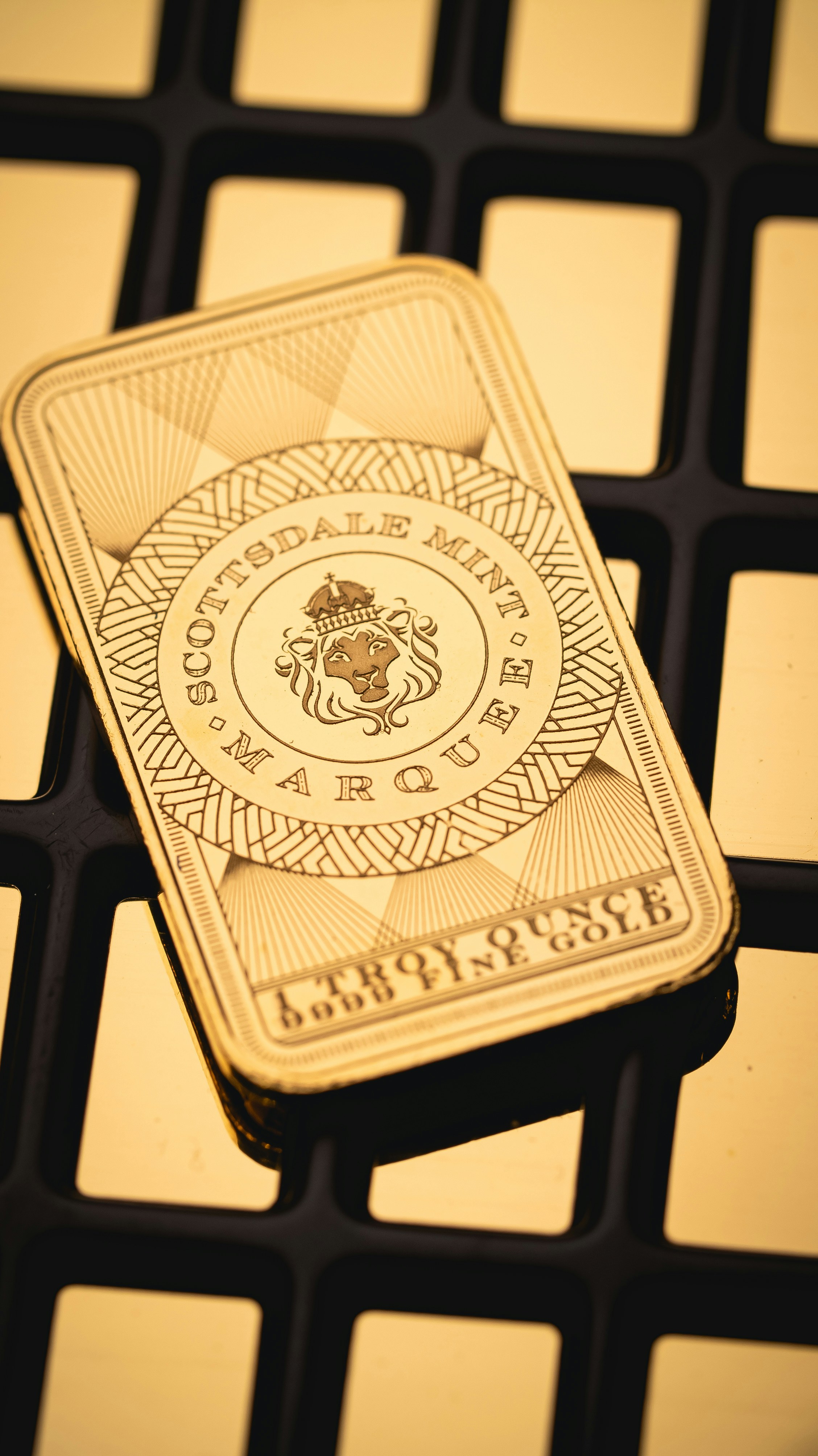 A gold playing card sitting on top of a computer keyboard