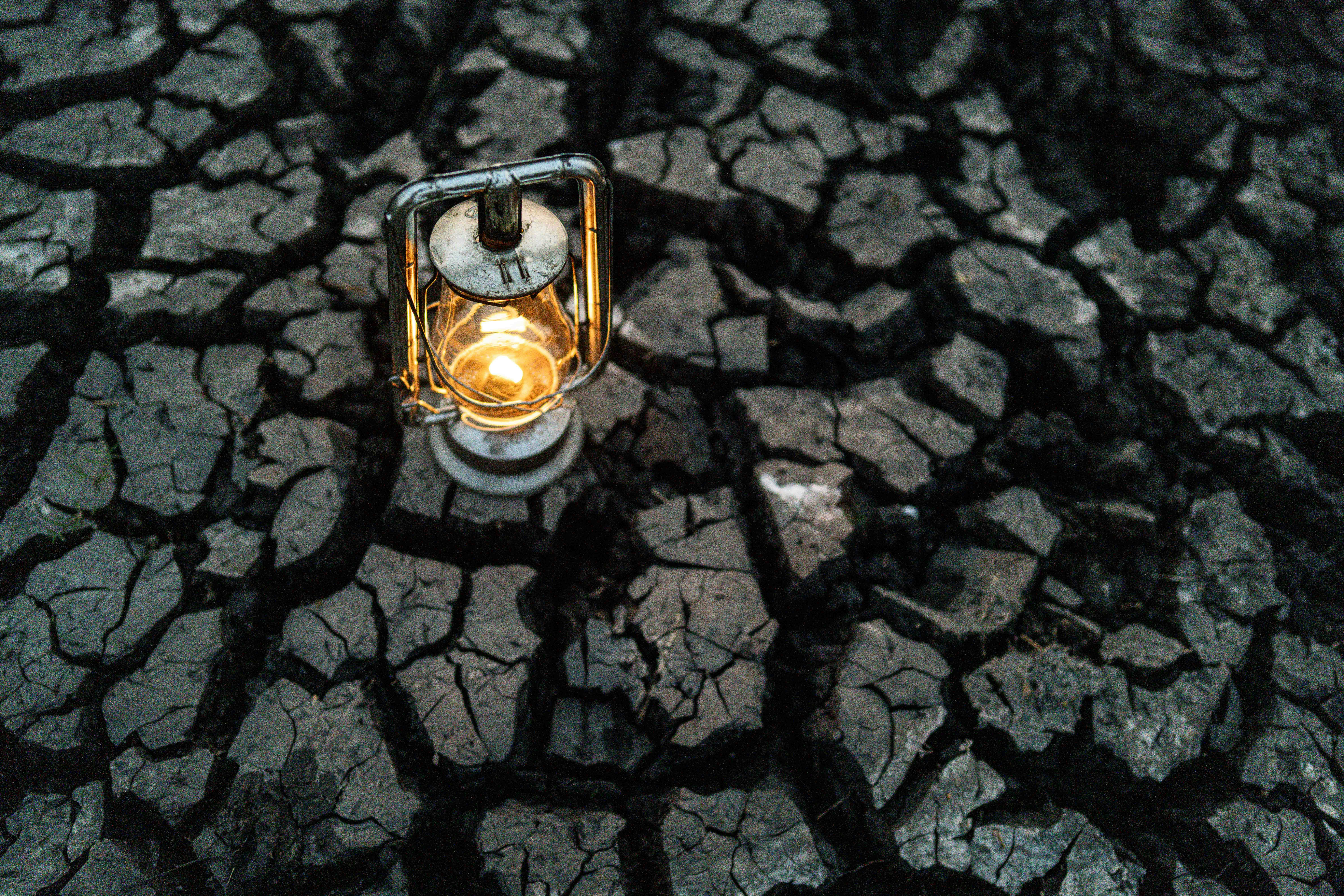 A lantern is sitting on a cracked surface