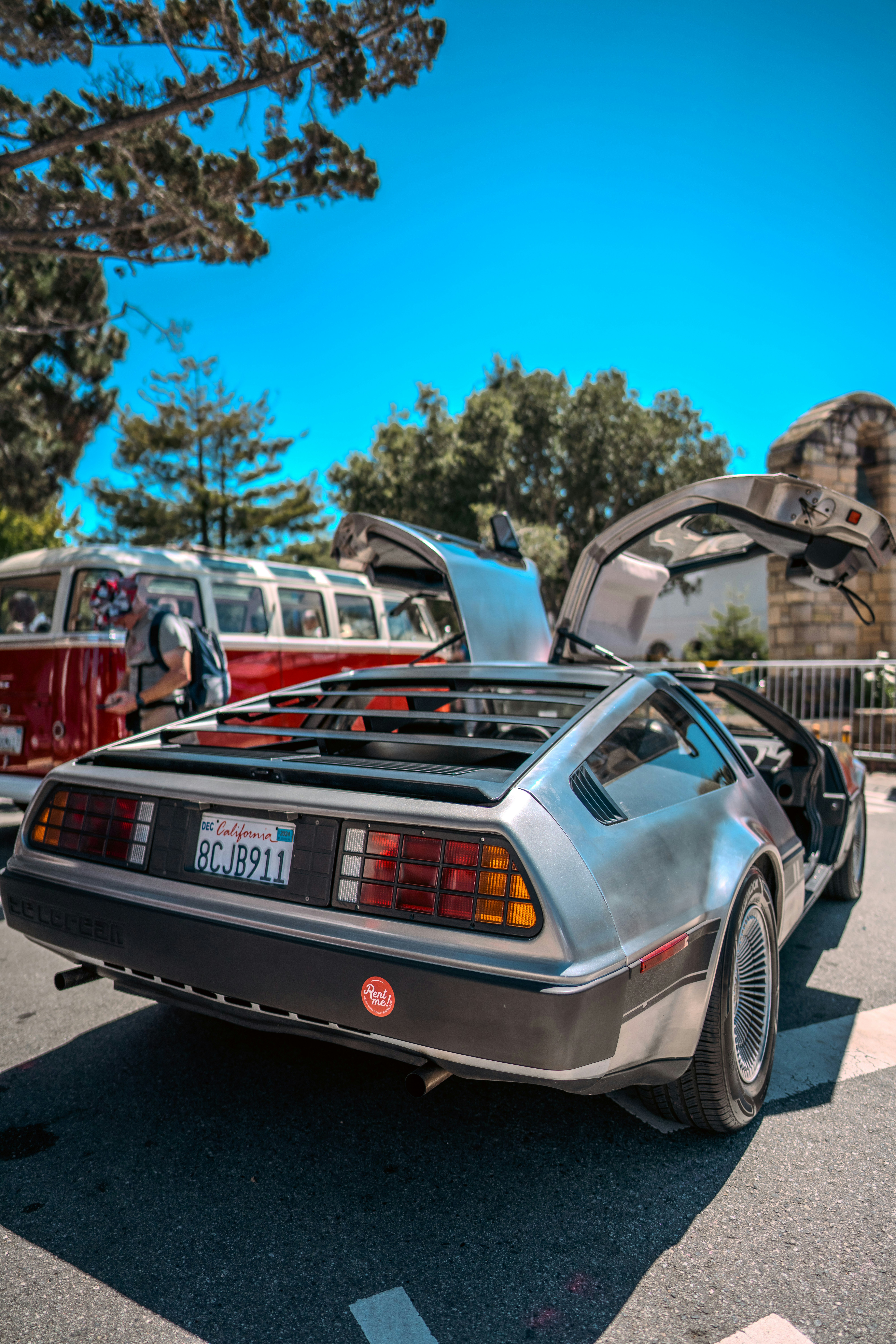 A car with its hood open parked in a parking lot