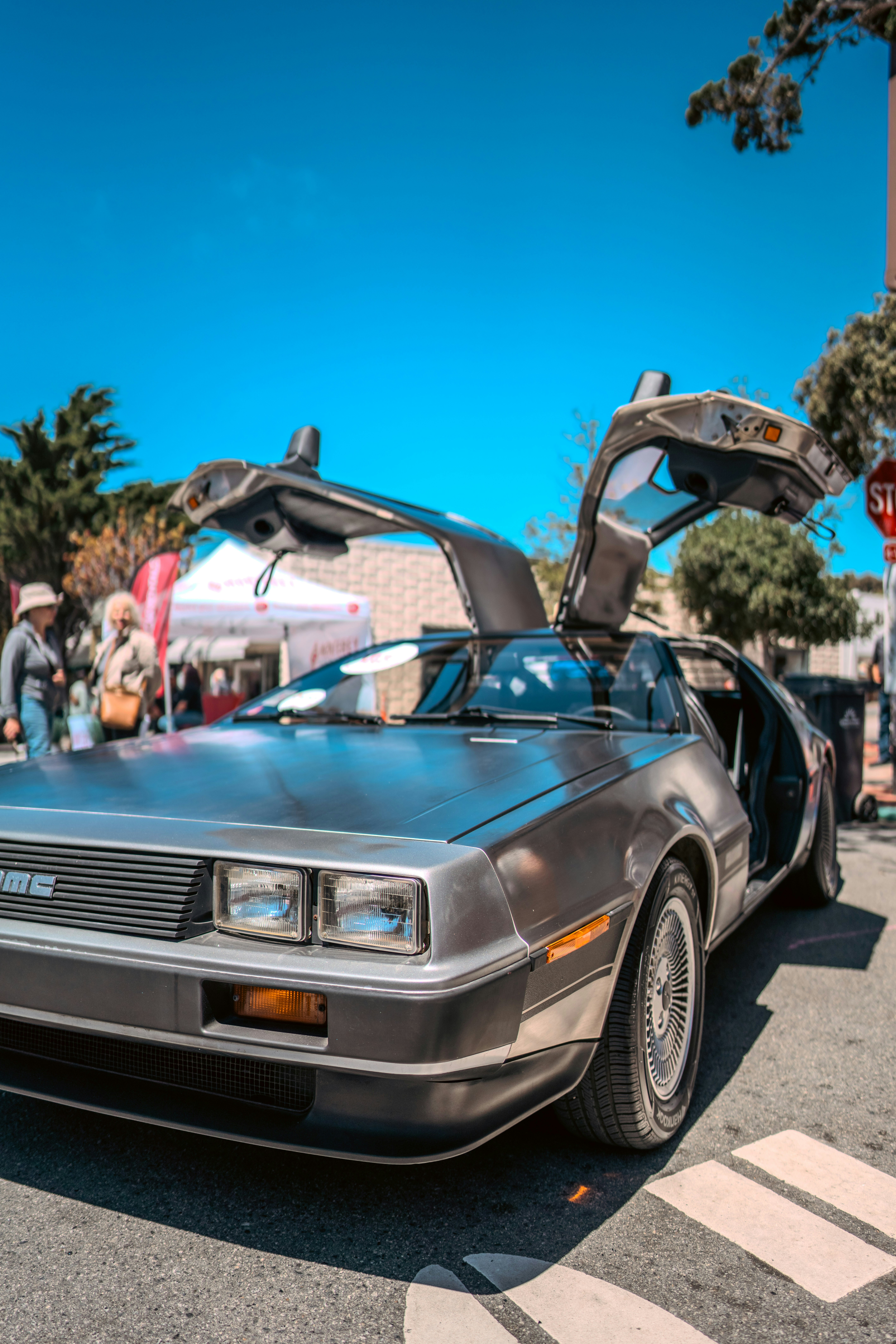 A silver delore is parked on the side of the road