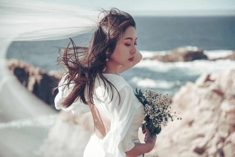 woman in white dress holding a bouquet
