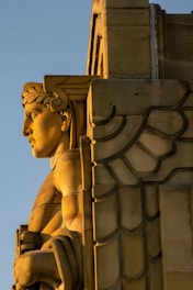 A close up of a statue on a building
