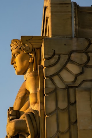 A close up of a statue on a building