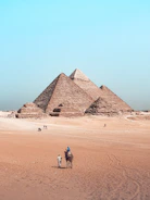 A man riding a horse in front of the pyramids of giza