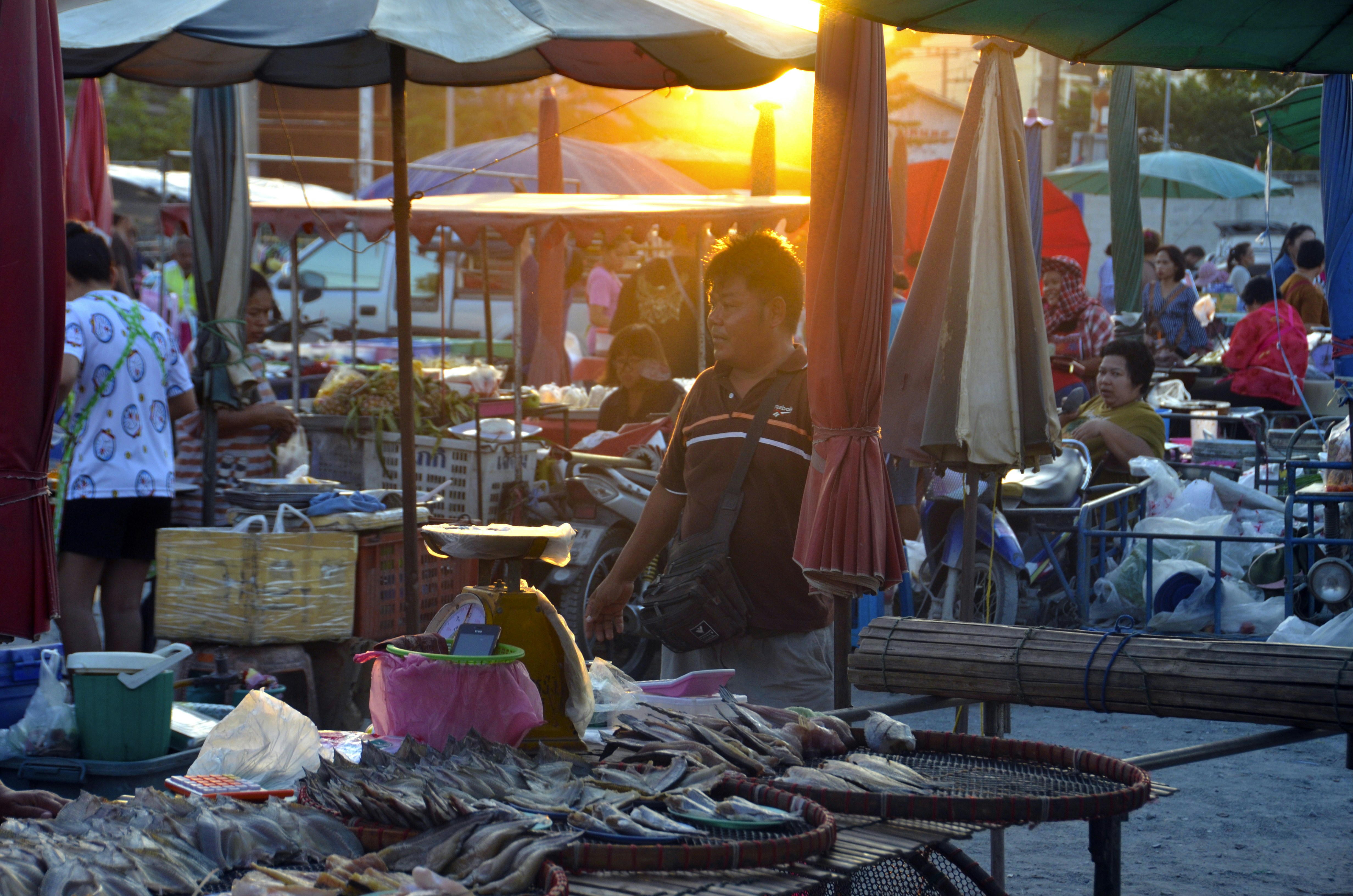 A group of people standing around a market