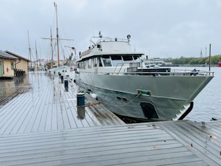 A boat docked at a dock in the rain