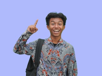 A man with a backpack giving a peace sign