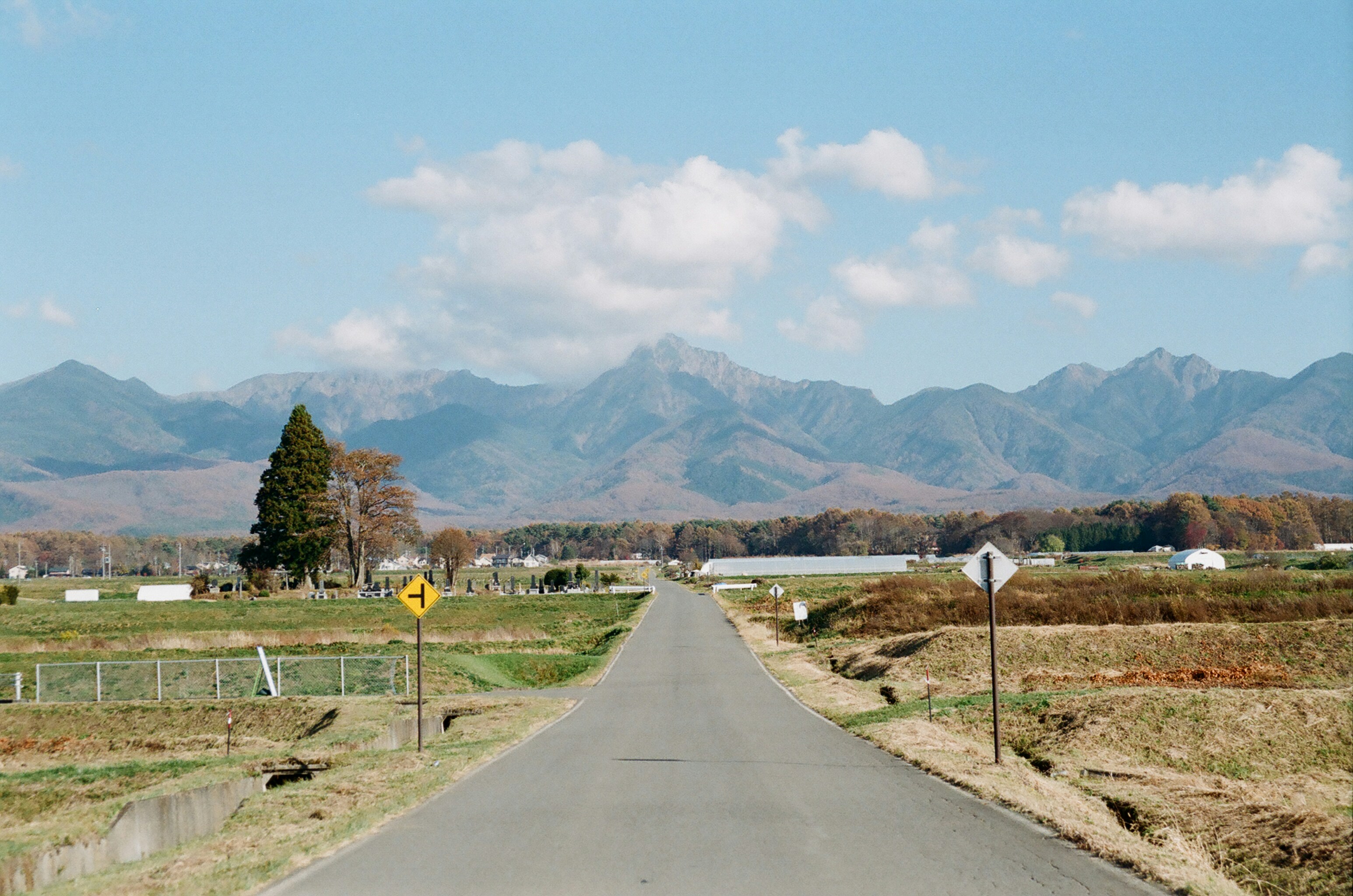 An empty road with mountains in the background
