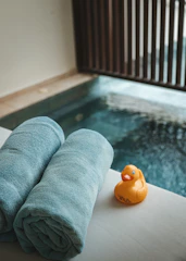 A couple of towels sitting next to a pool
