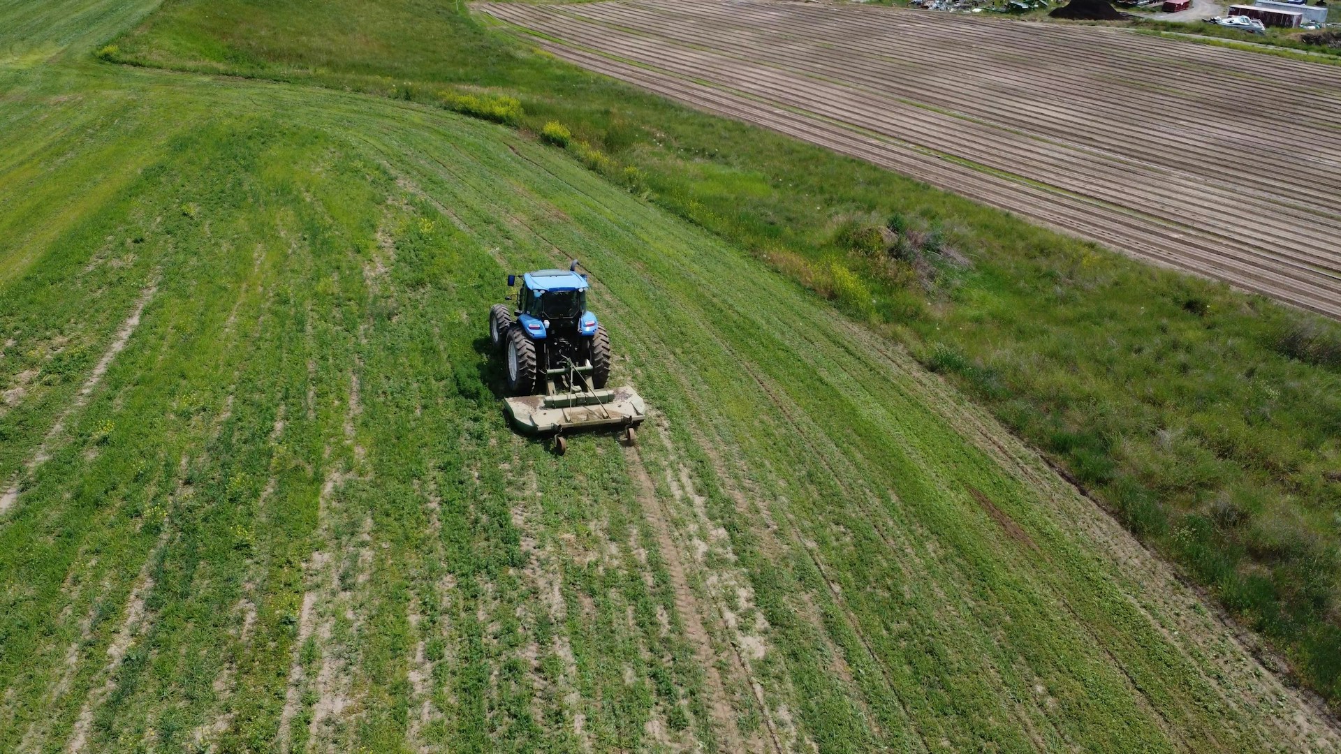 An aerial view of a tractor in a field
