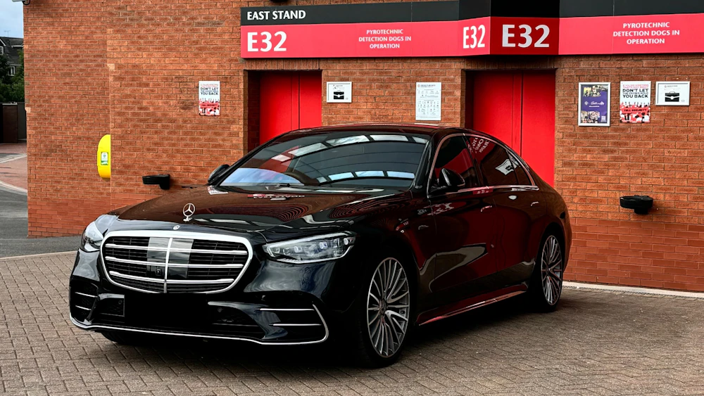Black car waiting outside an office building
