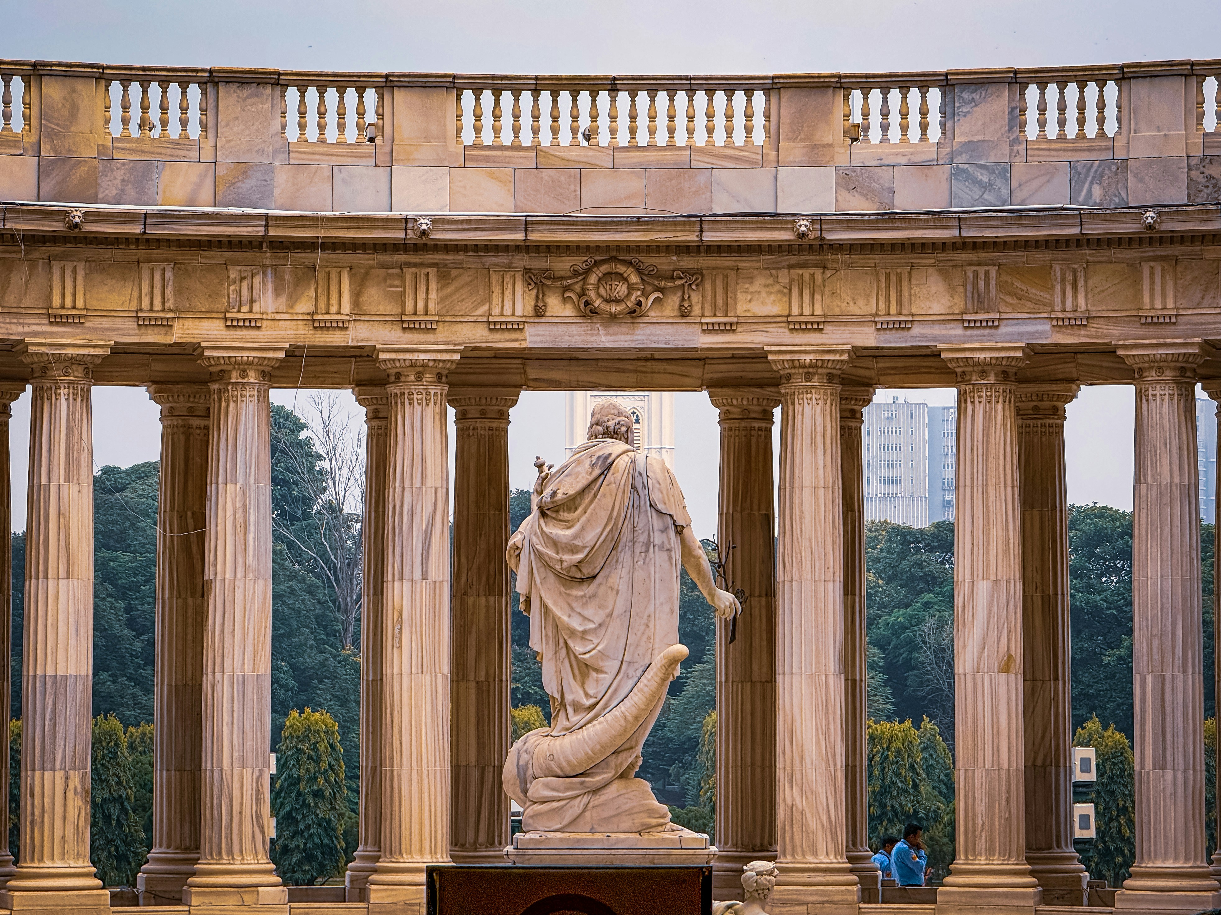 A statue in front of a building with columns photo – Free Man Image on ...
