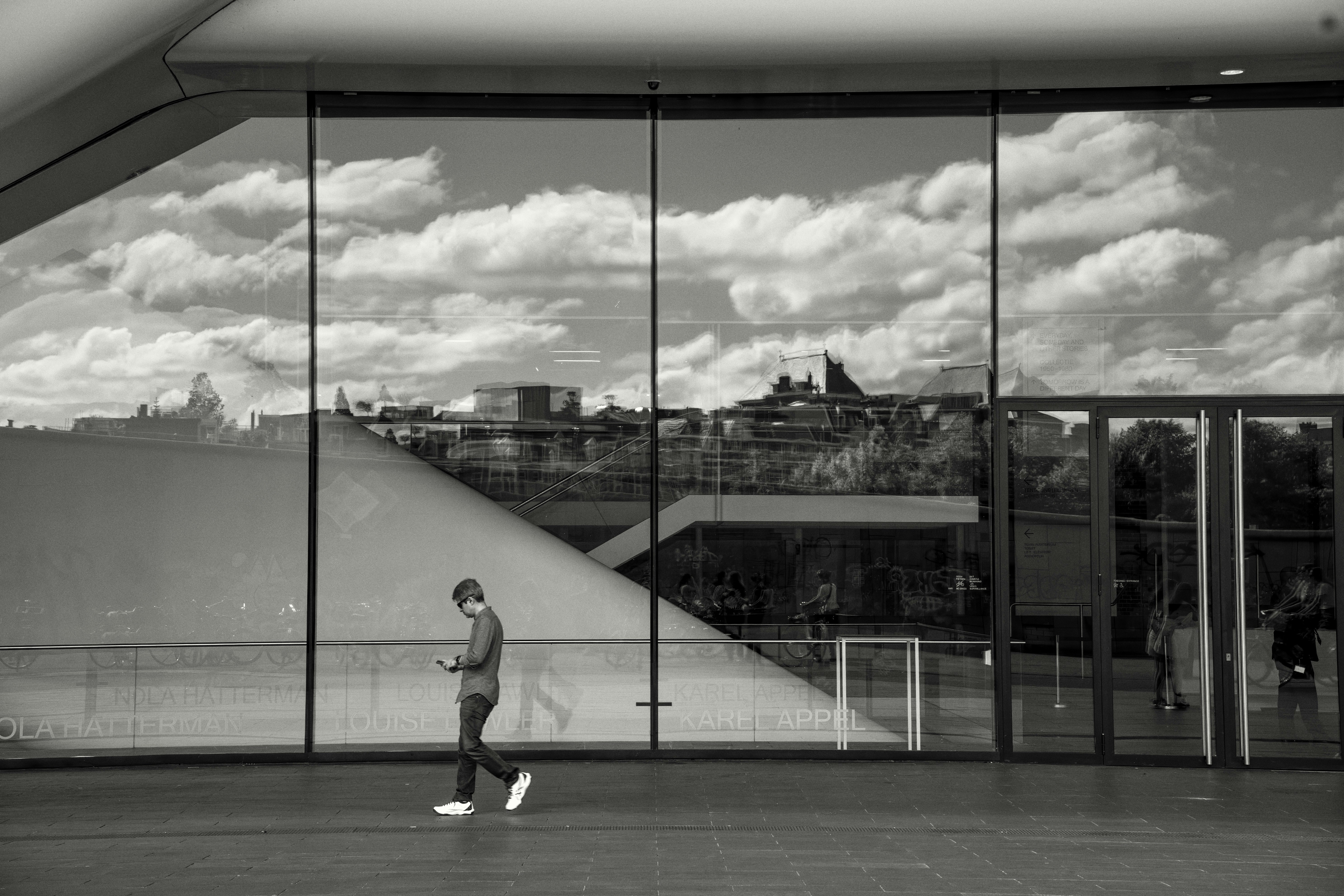 A man standing in front of a large window