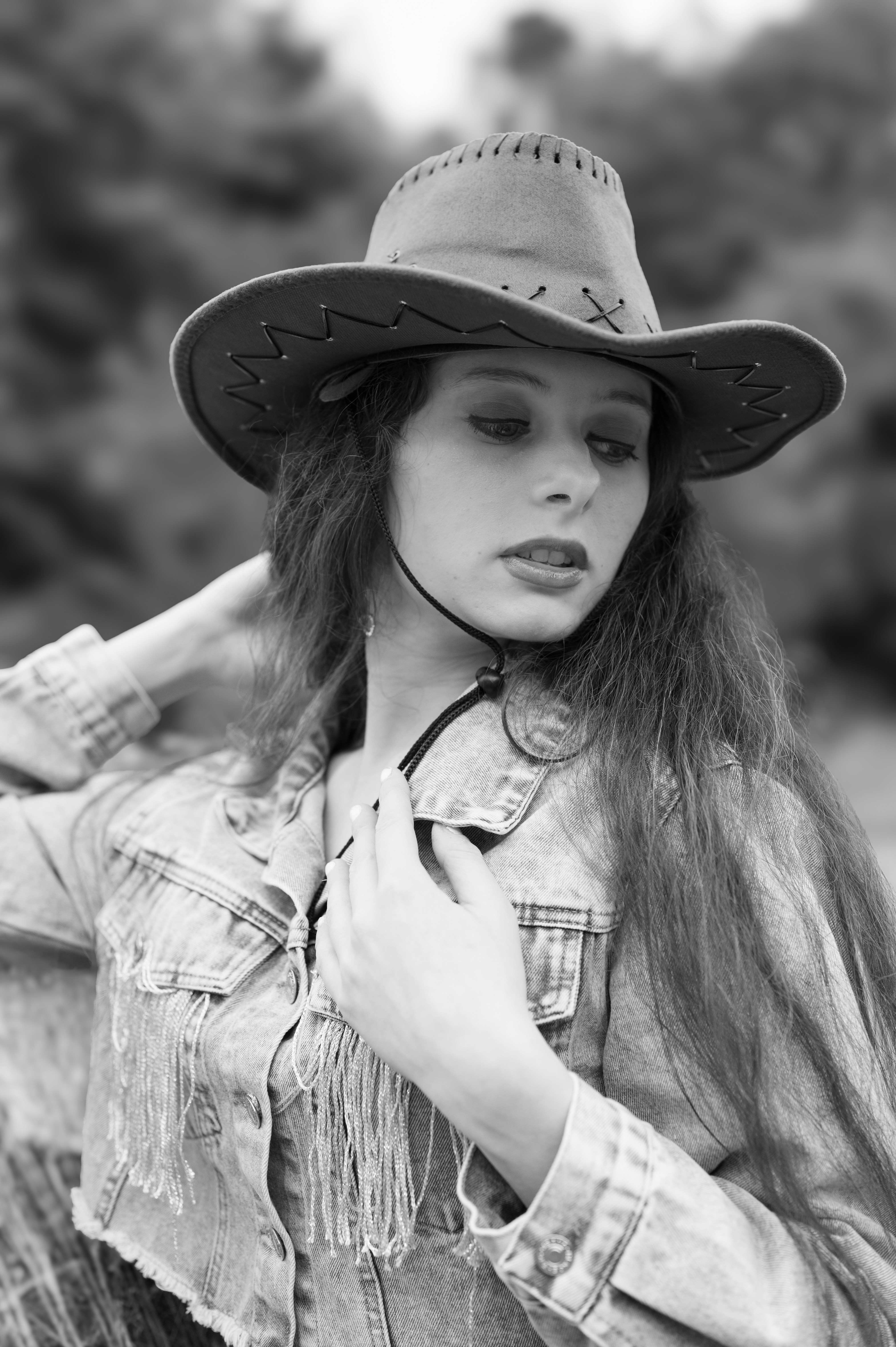 A woman with long hair wearing a cowboy hat