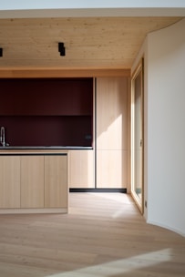 A kitchen with a wooden floor and cabinets