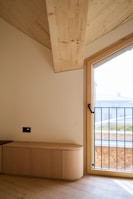 A room with a large window and a bench