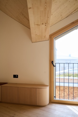 A room with a large window and a bench