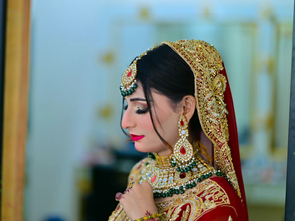 A woman in a red and gold bridal outfit