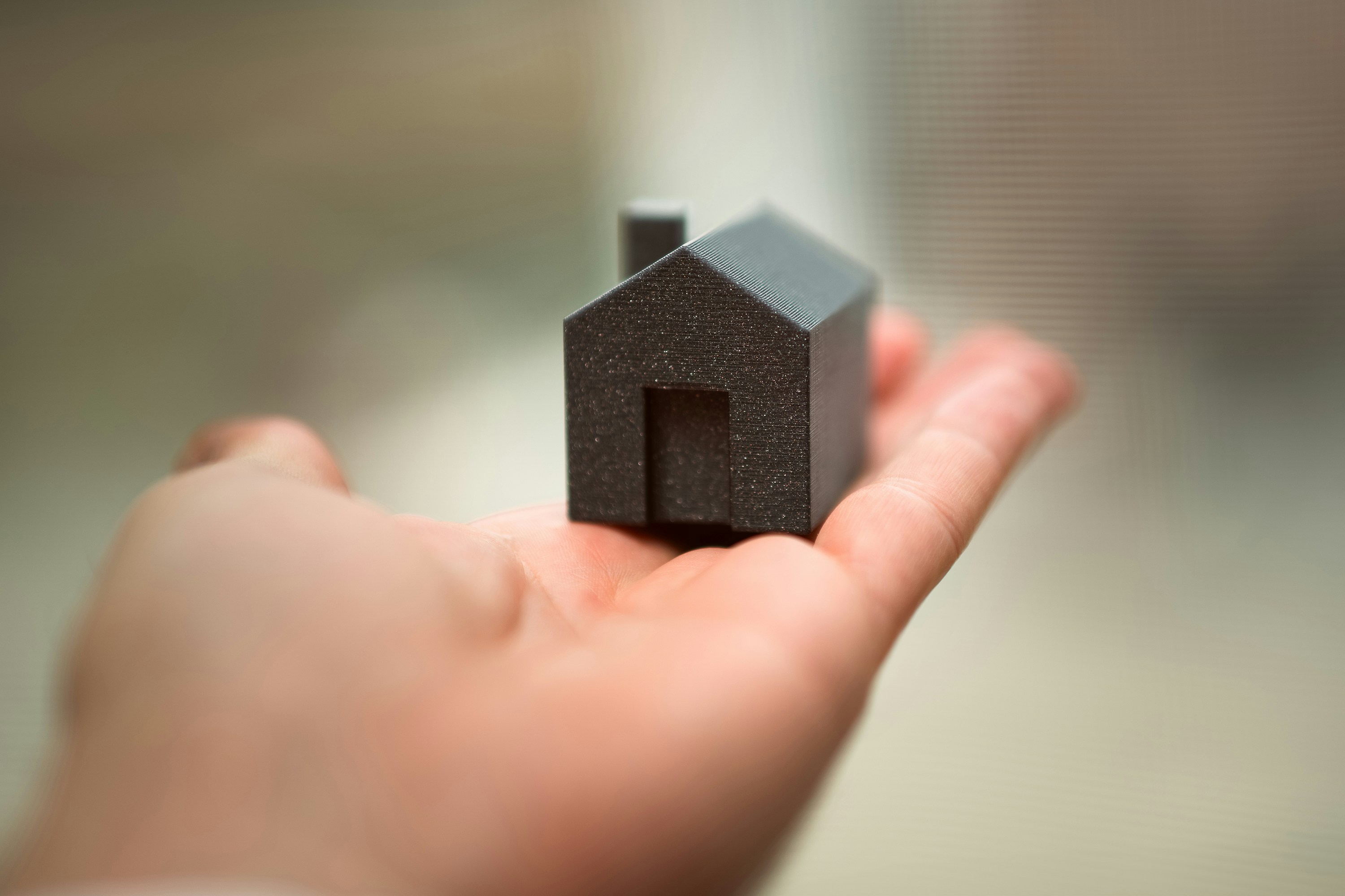 hand holding house real estate market purchase property selection