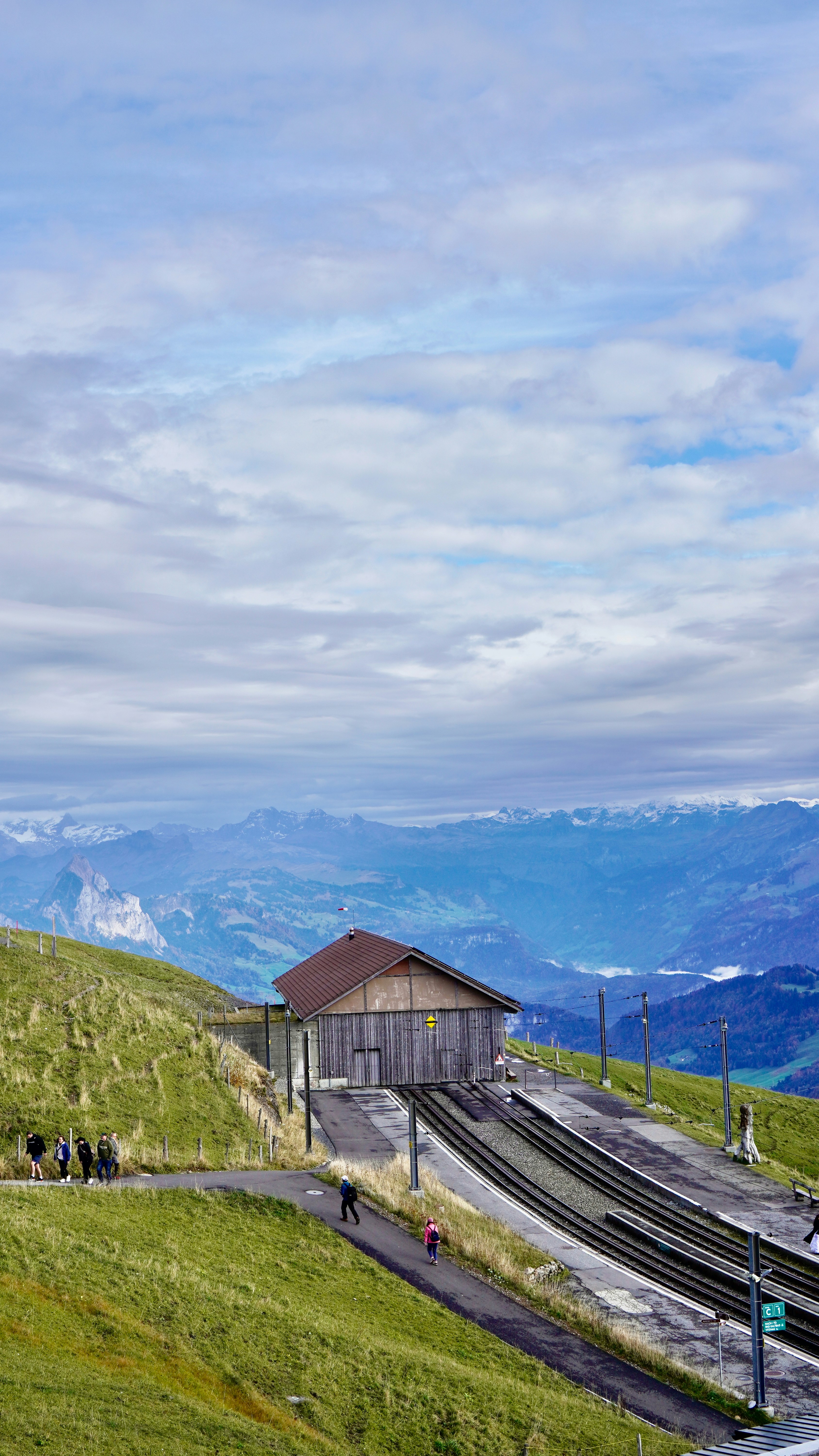 A scenic view of a train station on a hill