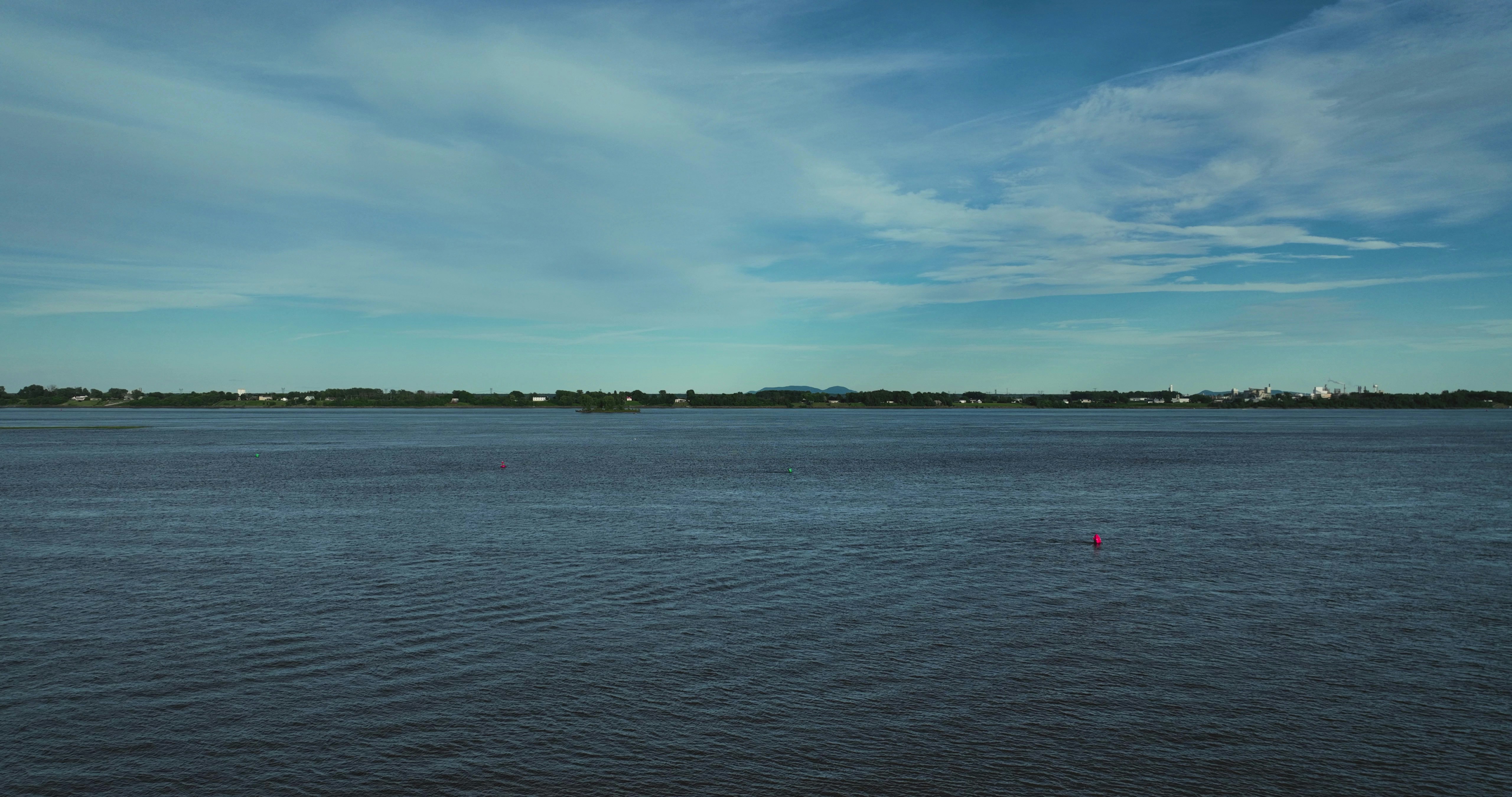 A body of water with a sky in the background