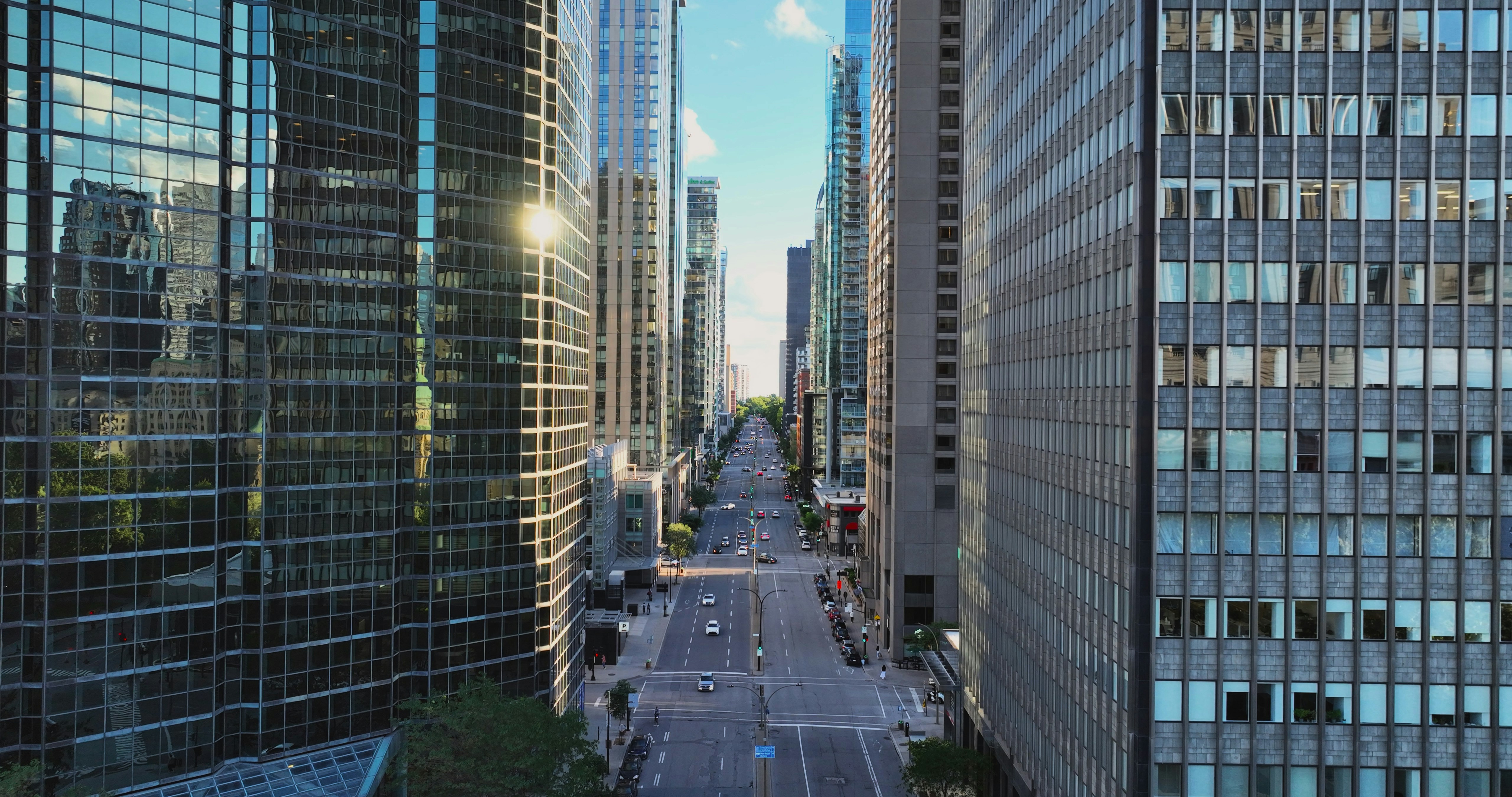A city street lined with tall buildings next to each other