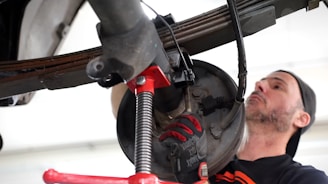 A man working on a vehicle in a garage