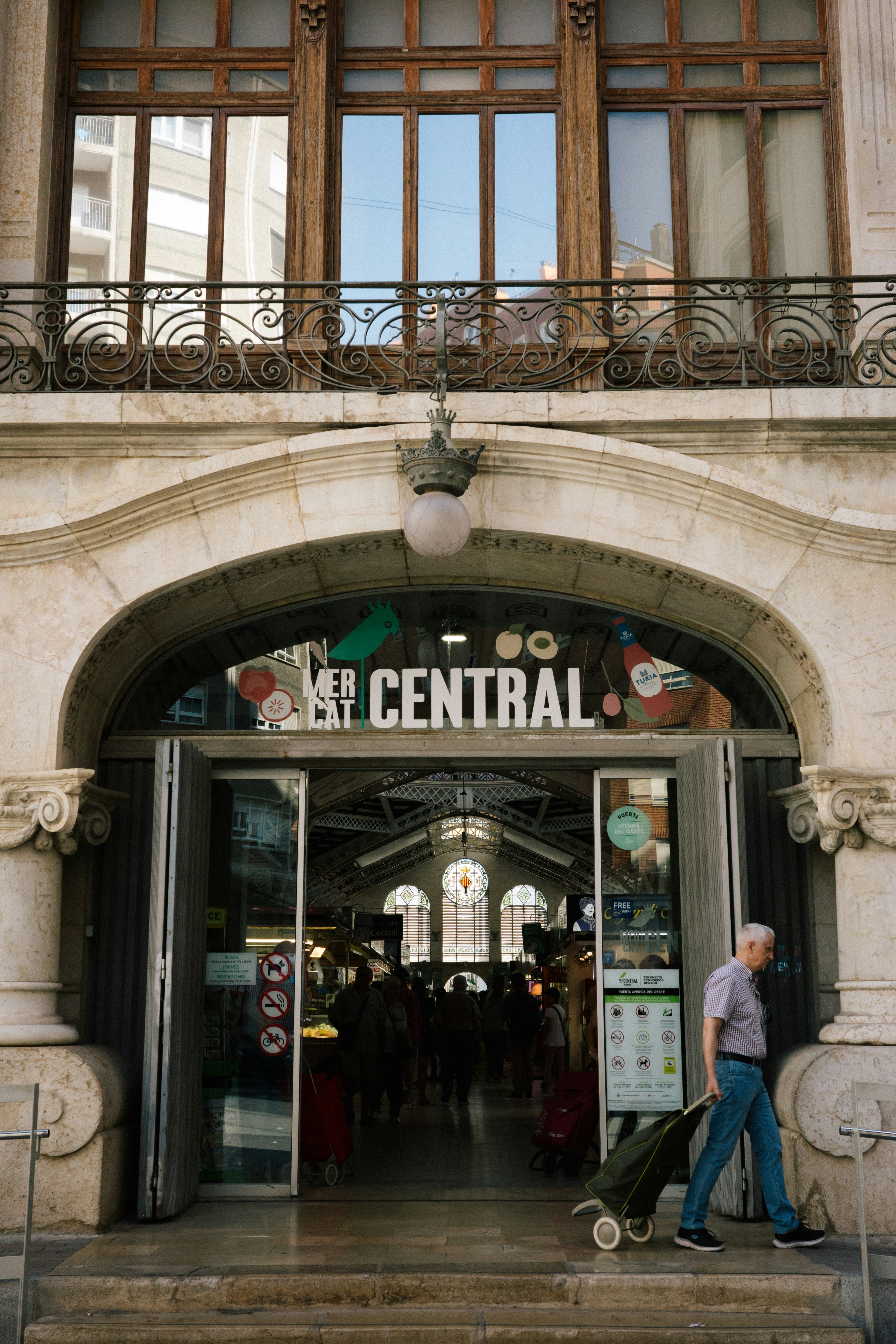 A man pulling a suitcase out of a building