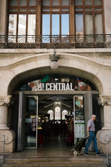 A man pulling a suitcase out of a building