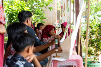 A group of people standing around a table