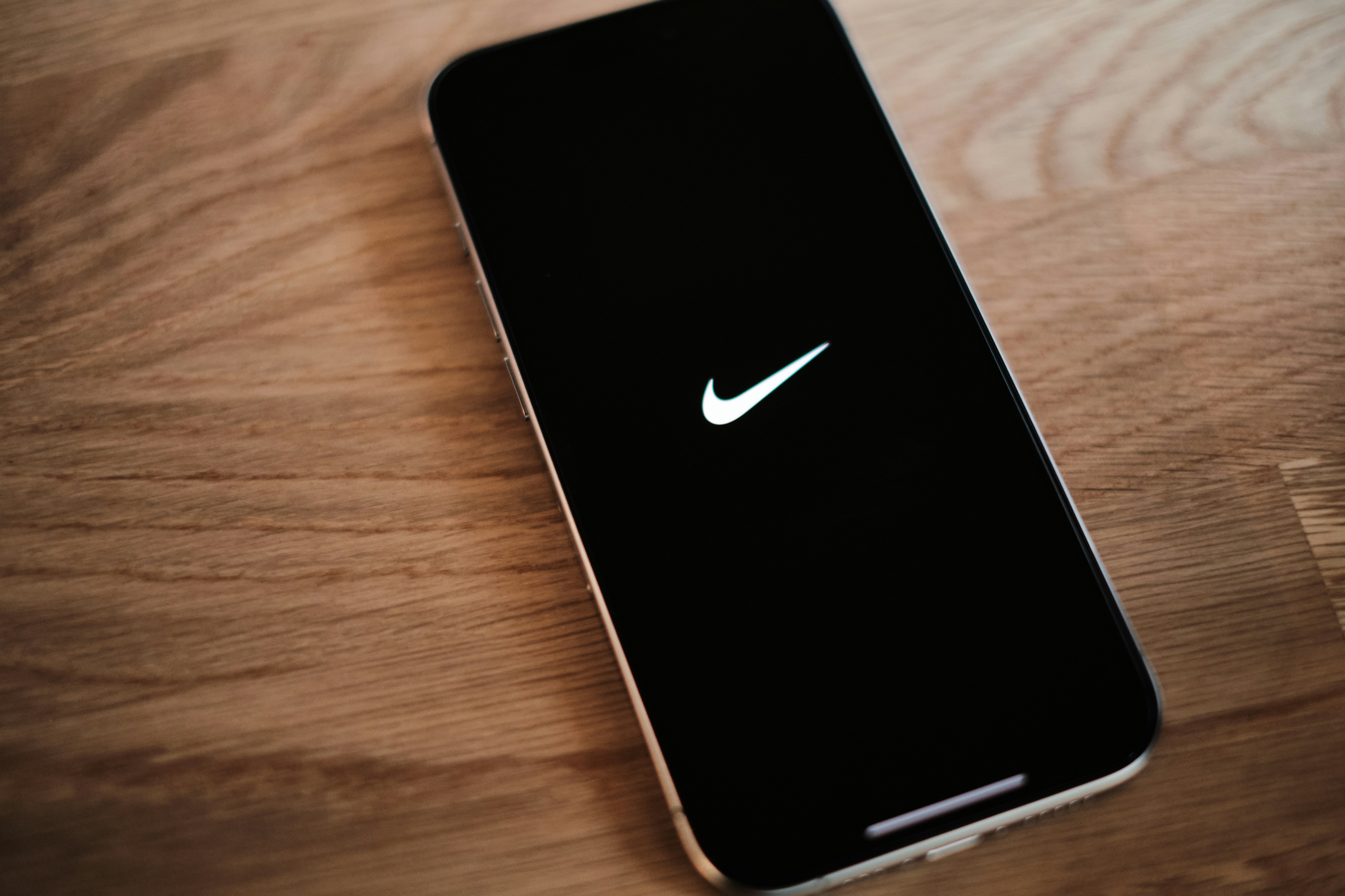 A black phone with a white nike logo on it